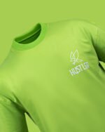 “Neon green t-shirt with embroidered Hustler logo – front angle view”